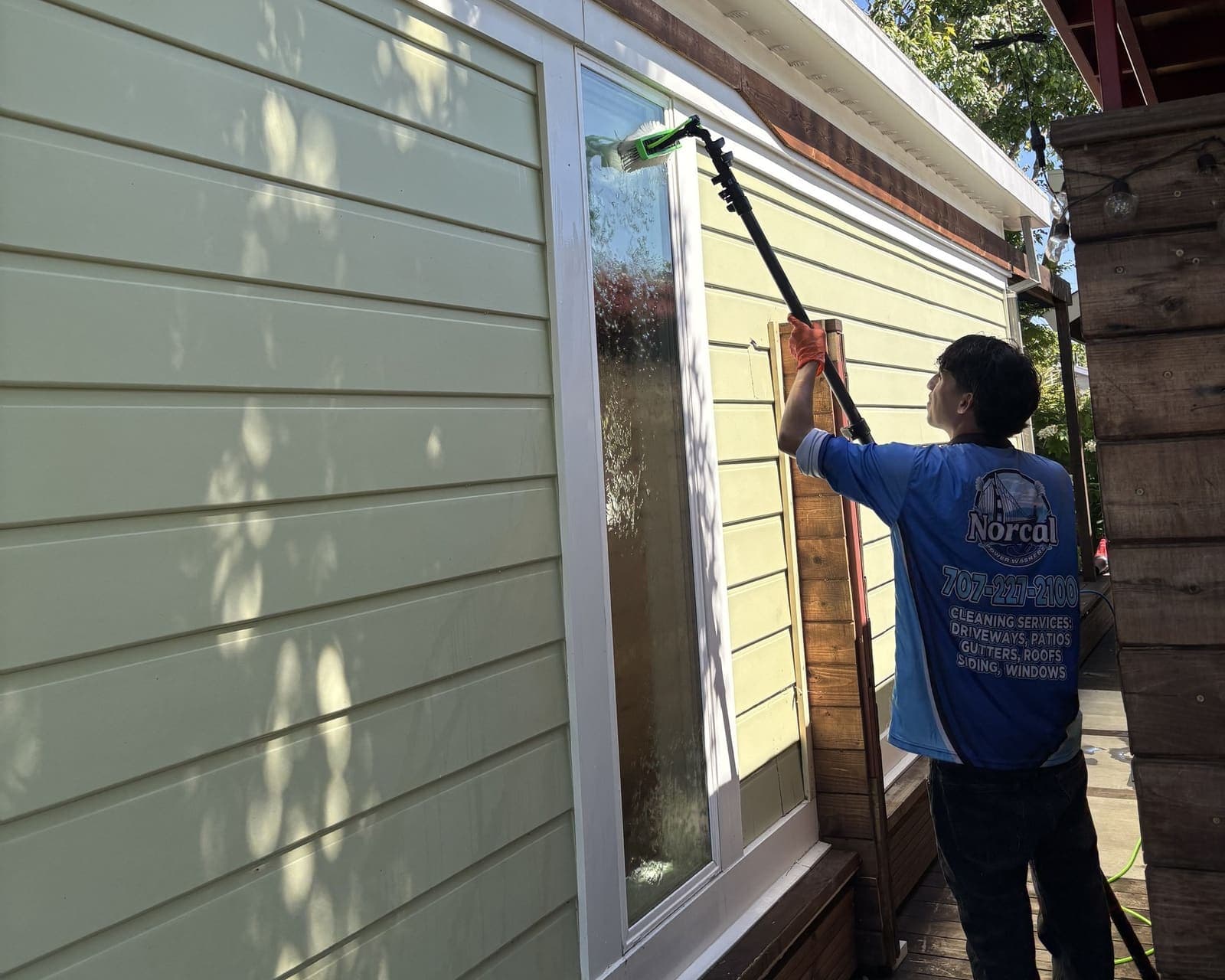 NorCal Power Washers technician cleaning windows with a water-fed pole system